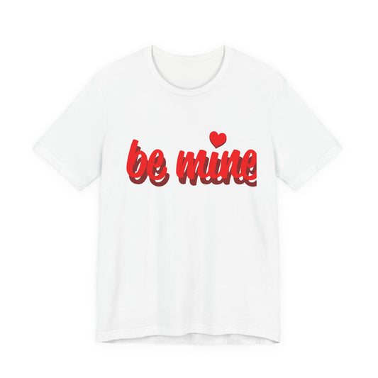 White t-shirt with 'be mine' text in red on a white background